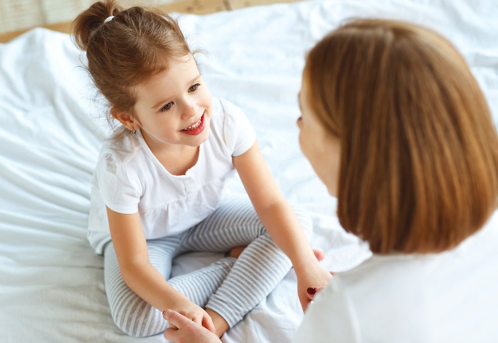 A mother talking to her child and calming her